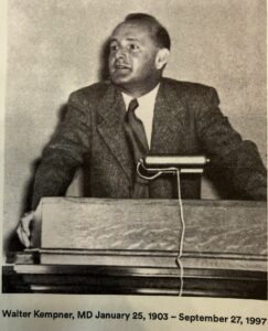 A man speaking at a podium with a microphone.